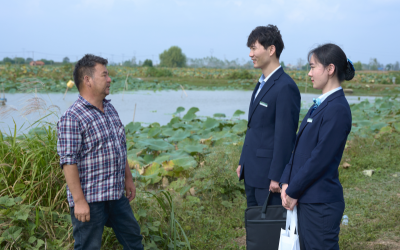 邮储银行工作人员在农业项目现场。